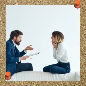 How to motivate employees: Communicate. Ask them what they want! This image shows two people talking over a notepad.