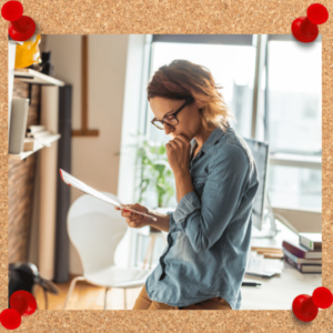 Quarterly performance review post image depicts female reading paperwork in an office setting.