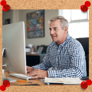 Image depicts middle aged man working on a computer.