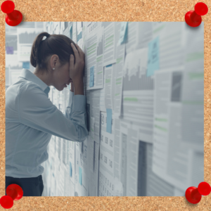 Smartly dressed female leans head against wall covered in papers.