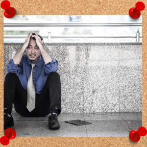 Learning from failure is essential to growth. Image depicts business man clearly stressed as he sits on a balcony.