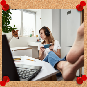 A woman sits in her office with her bare feet propped up on her desk, headphones on, and her phone held as though playing a game. She appears to be the epitome of a lazy coworker.