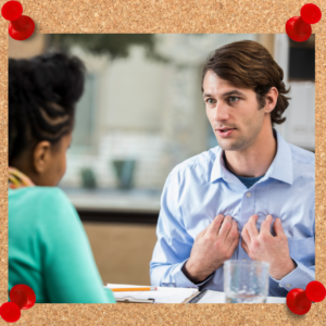 Vulnerability in leadership requires clear and open communication. The photo depicts such with a male coworker with fingertips touched to his own chest while speaking to a female coworker.